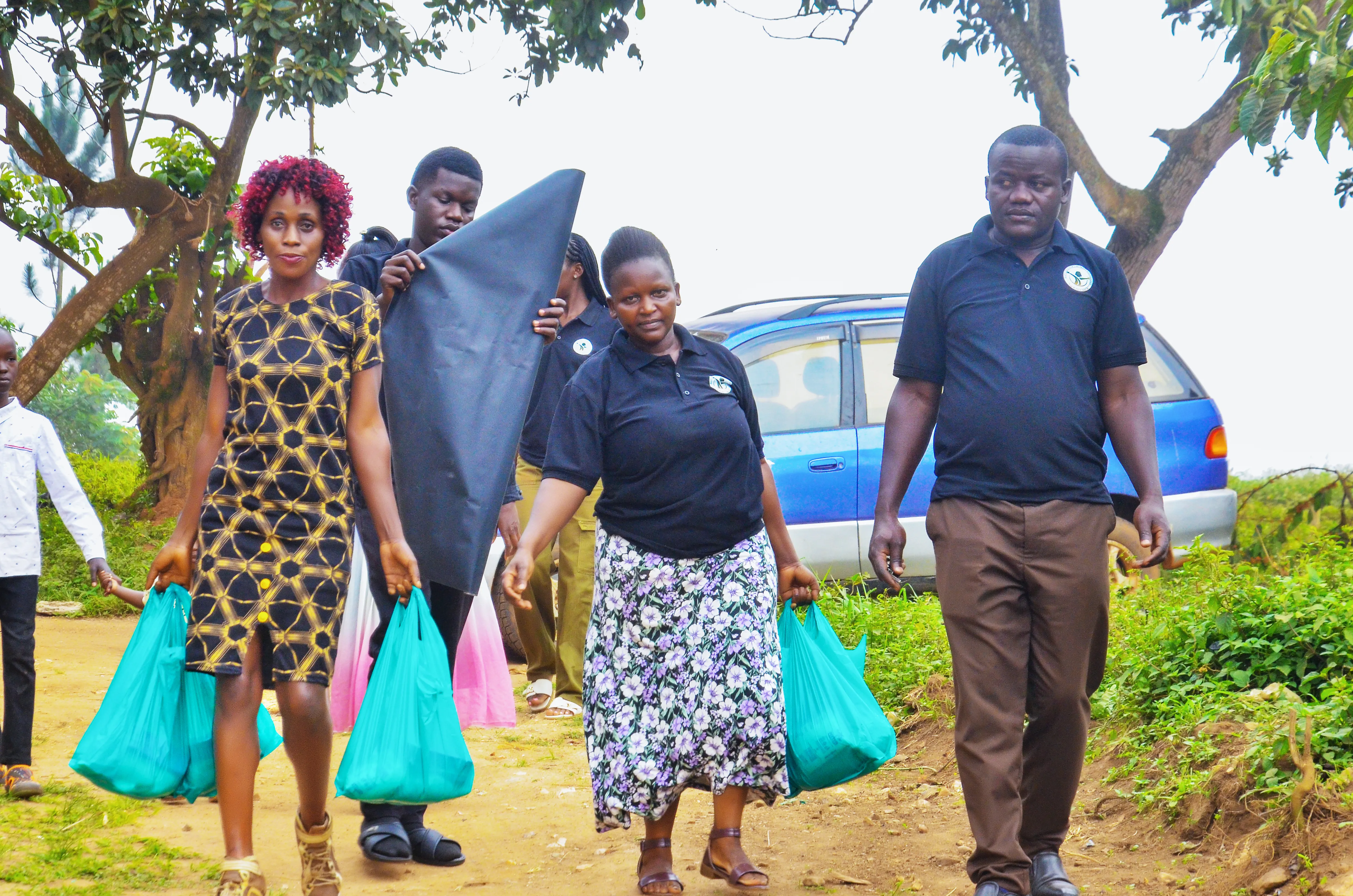 Outreach team distributing supplies in a village